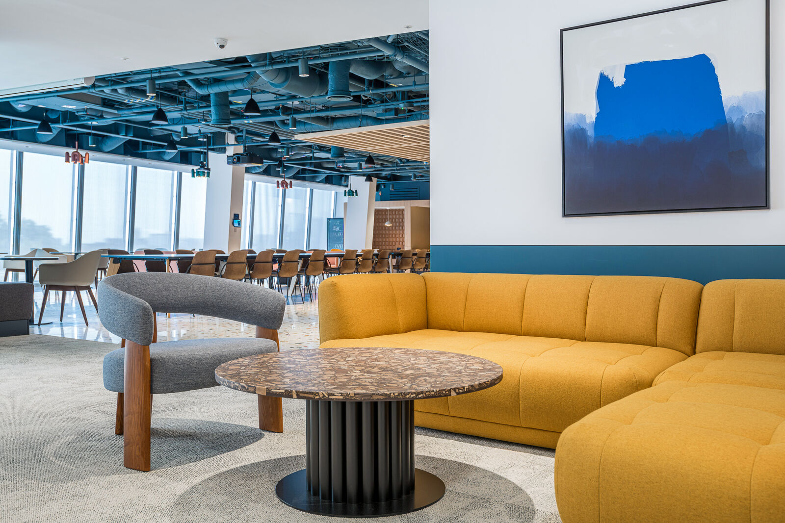 On the open floor the absorption moves overhead, into coloured baffles.