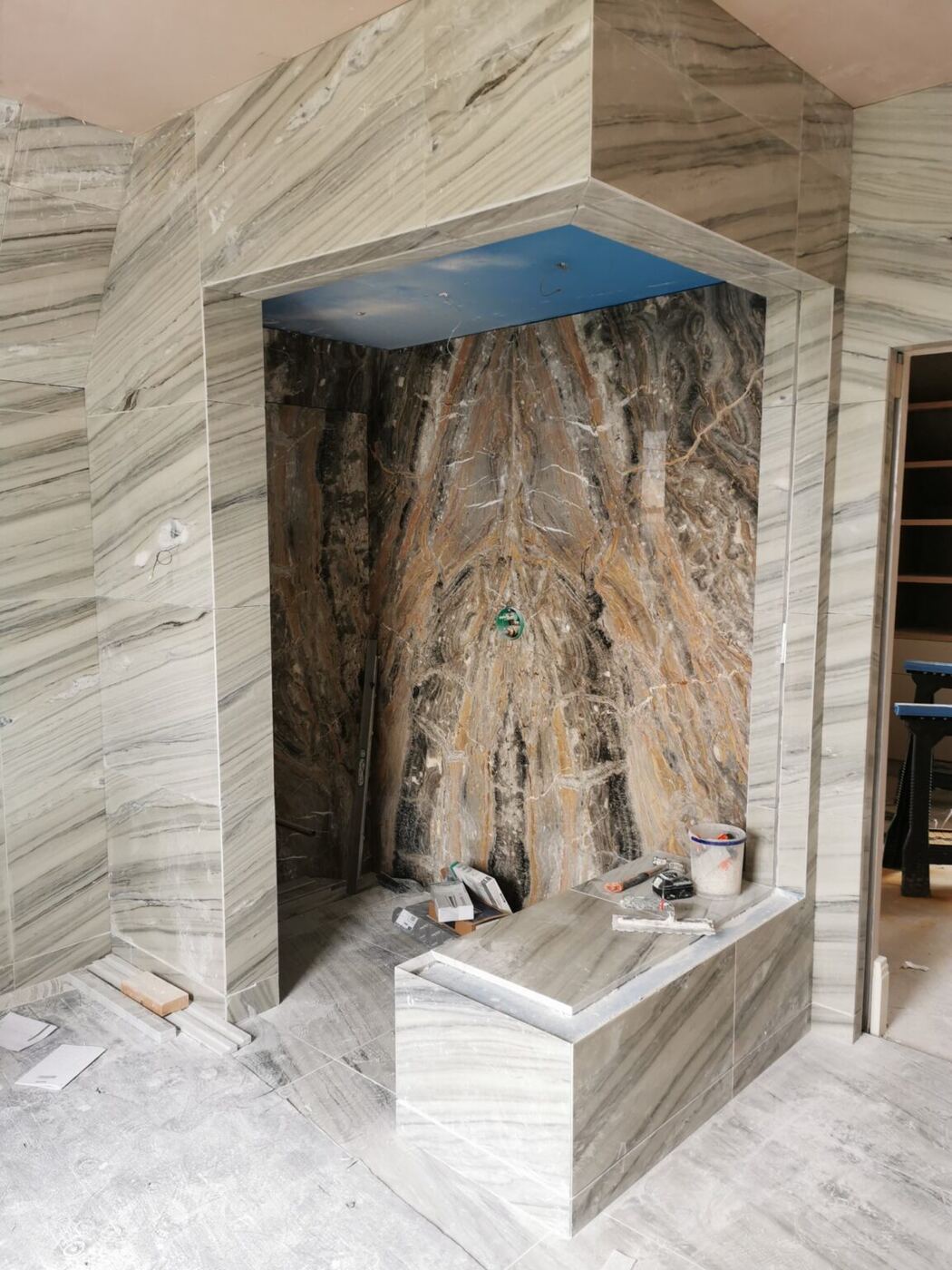 A book-matched feature wall in a shower to match